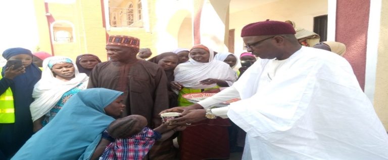The Representative of the Shehu of Bama Alhaji Abba Kaumi flagging up the program by feeding an Infant with the prepared Kwaspap.